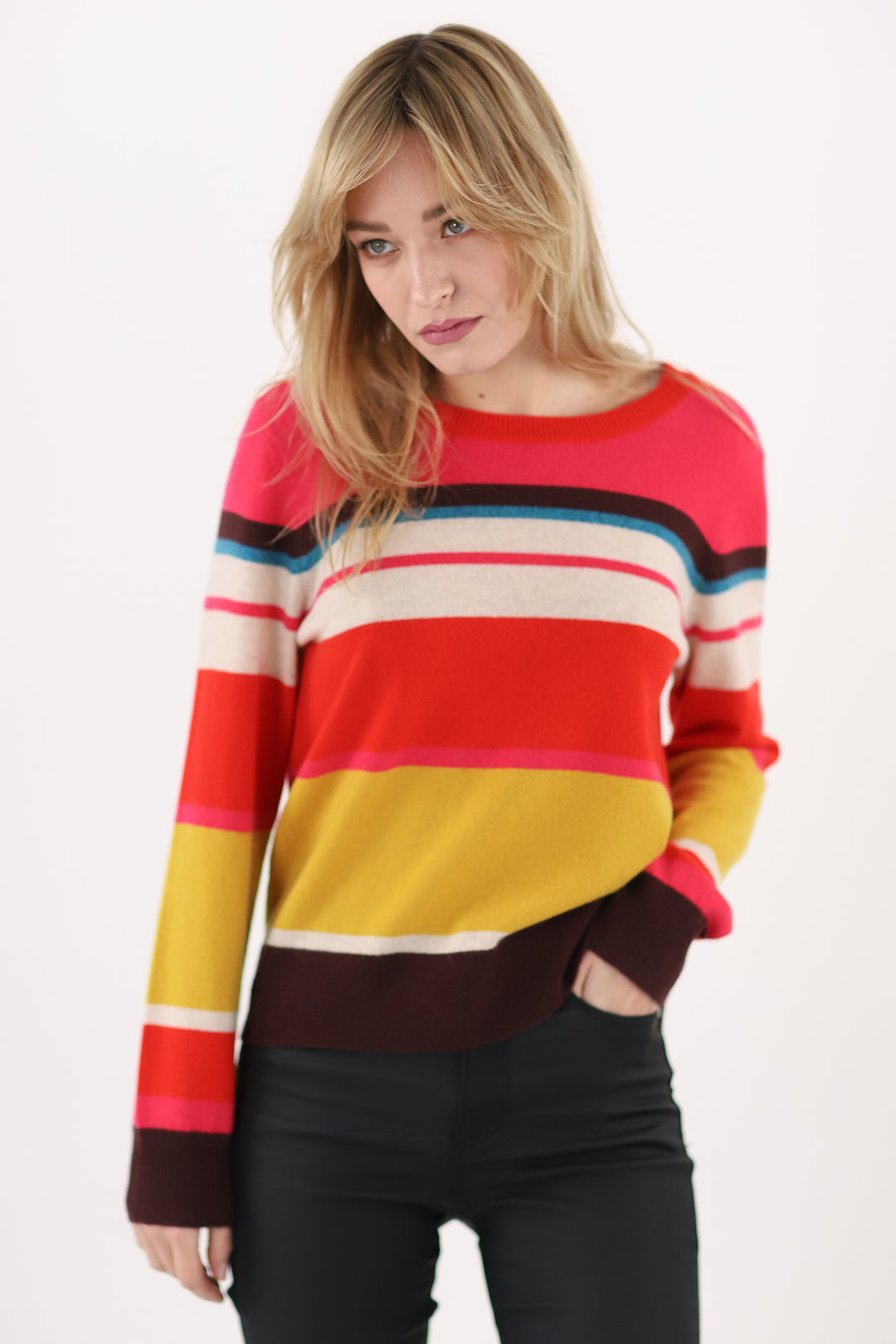 Woman wearing a colorful striped sweater on a white background