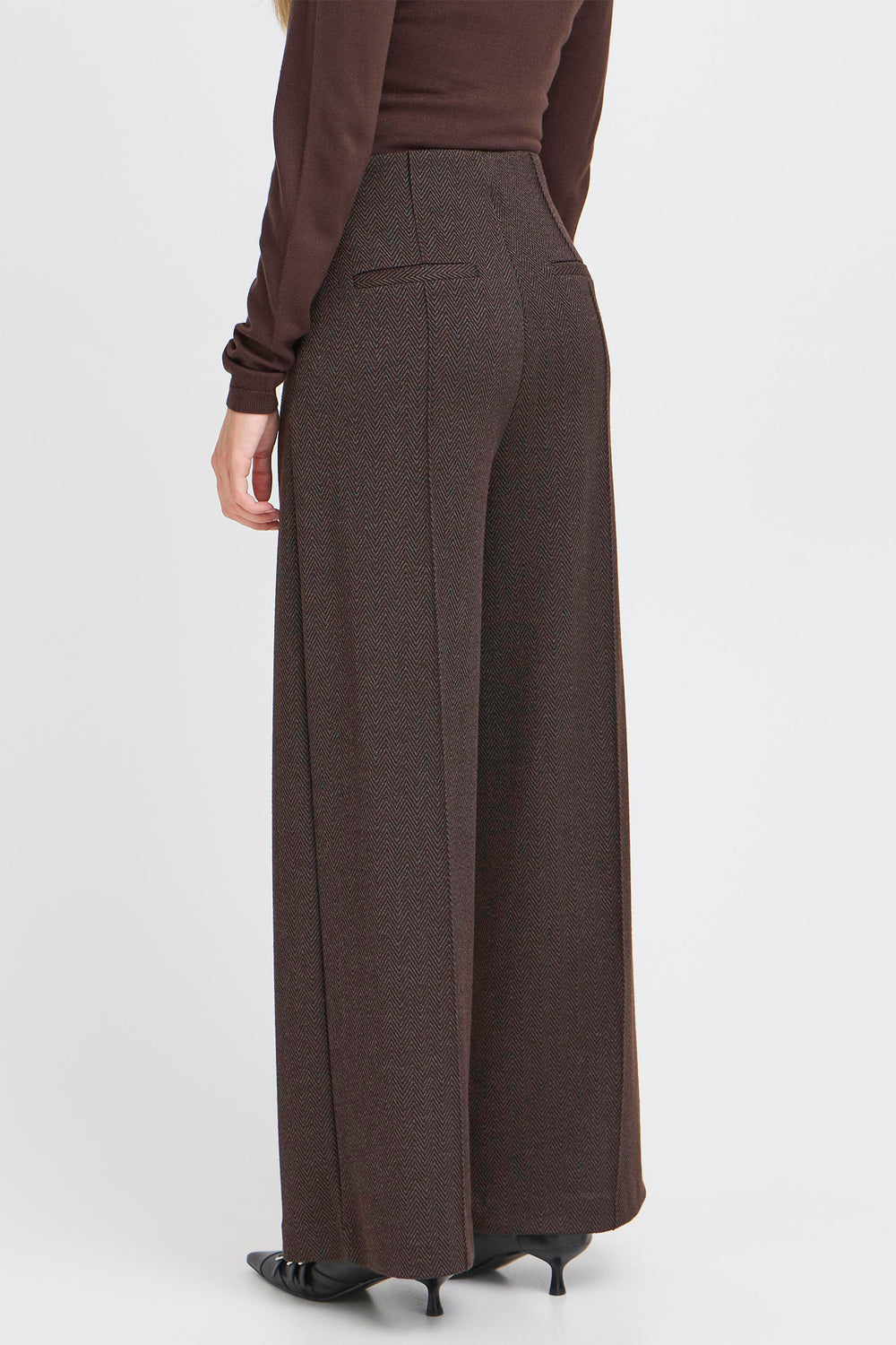 Brown wide-leg pants worn by a person on a white background