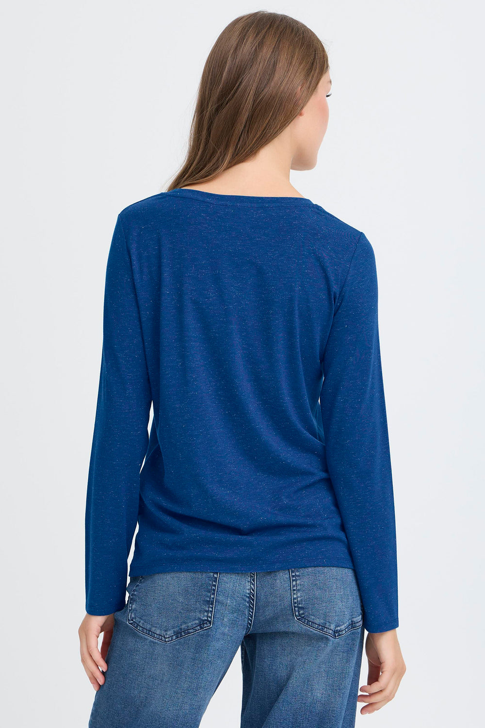 Person wearing a blue long-sleeve top and jeans on a white background
