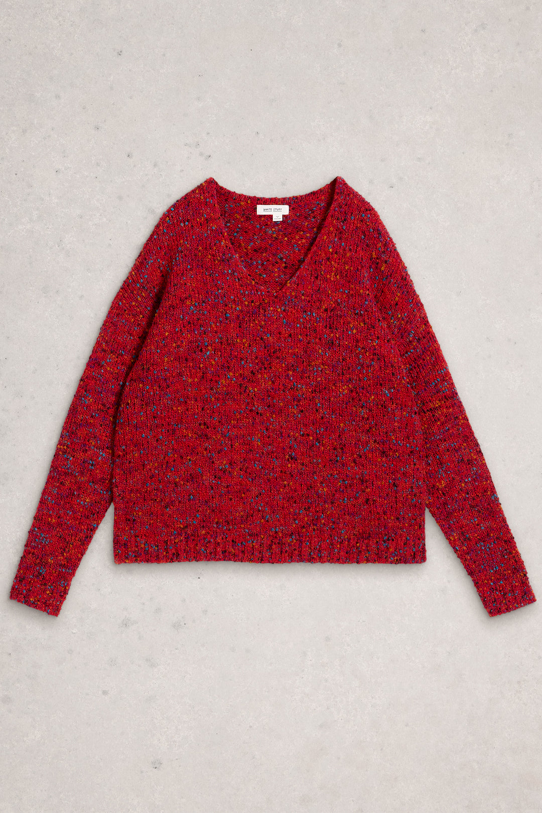 Red patterned sweater on a light gray background