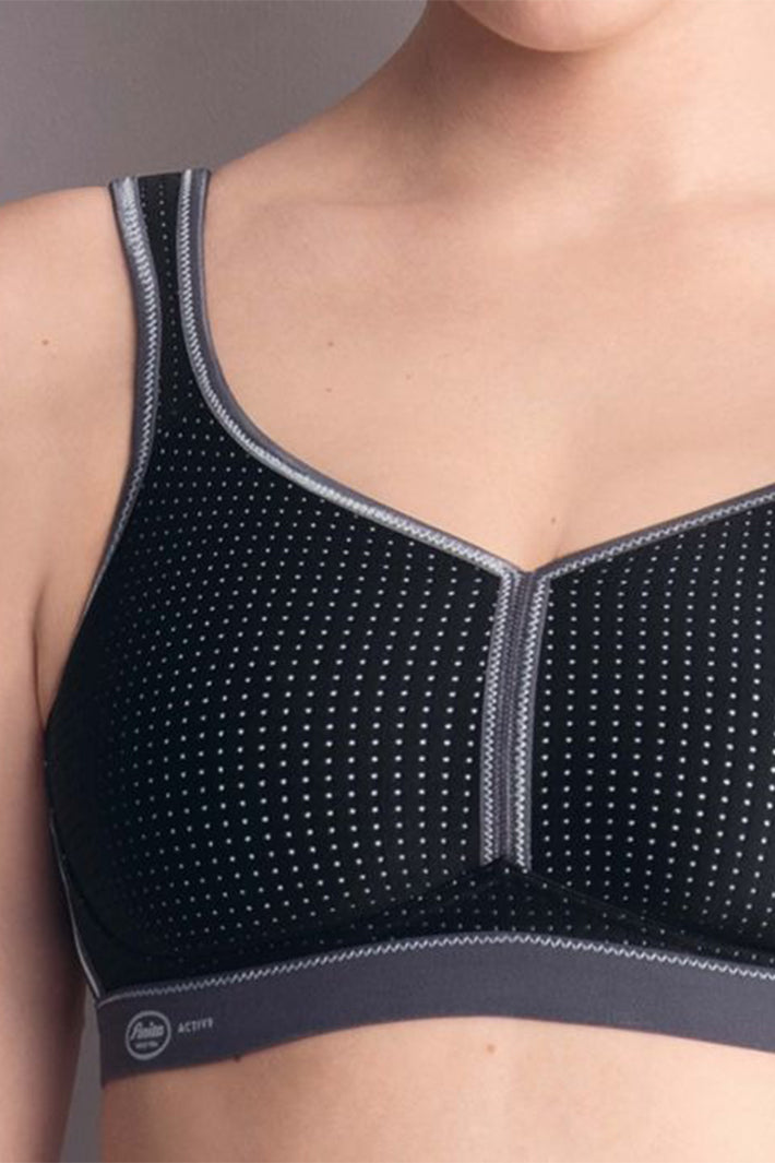 Black sports bra with gray accents on a neutral background