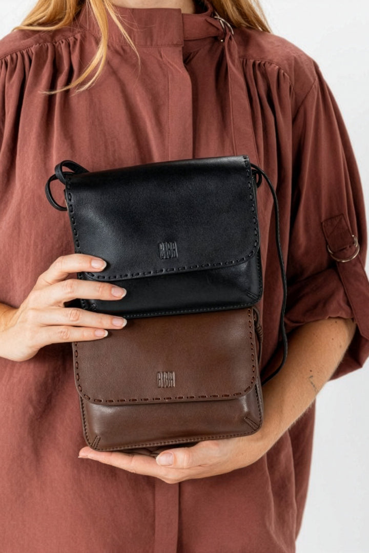 Biba Hatch Black Leather Cross Body Bag HAH1L, held in the hands, flap detail