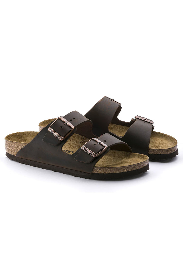 Pair of brown sandals with buckles on a white background