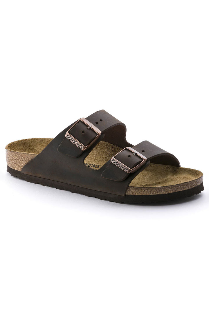 Brown sandal with two buckles on a white background