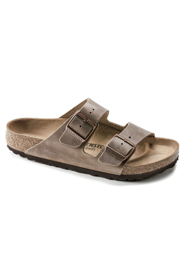 Brown sandal with 'Birkenstock' branding on a white background