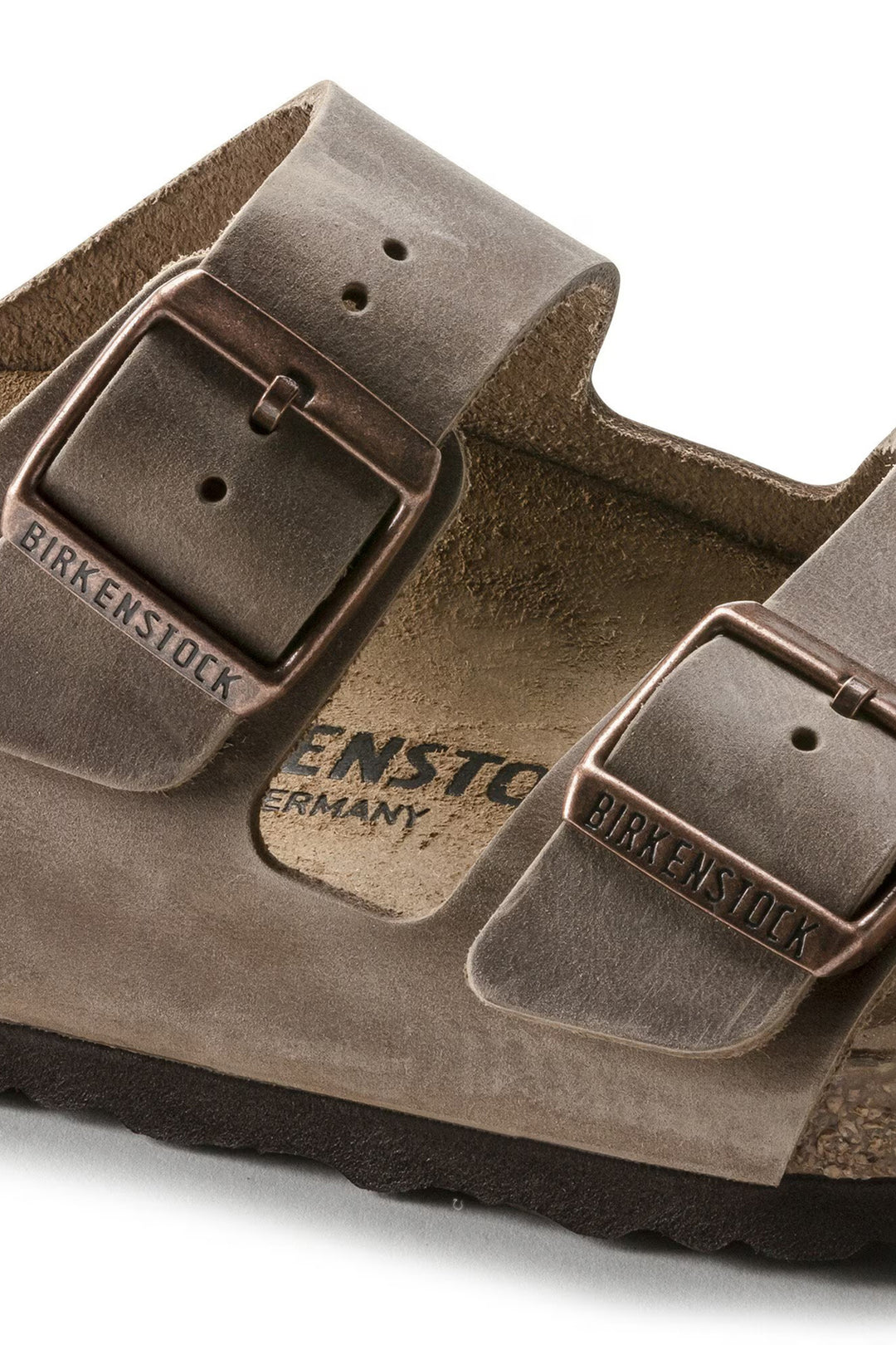 Brown Birkenstock sandal with buckle on a white background