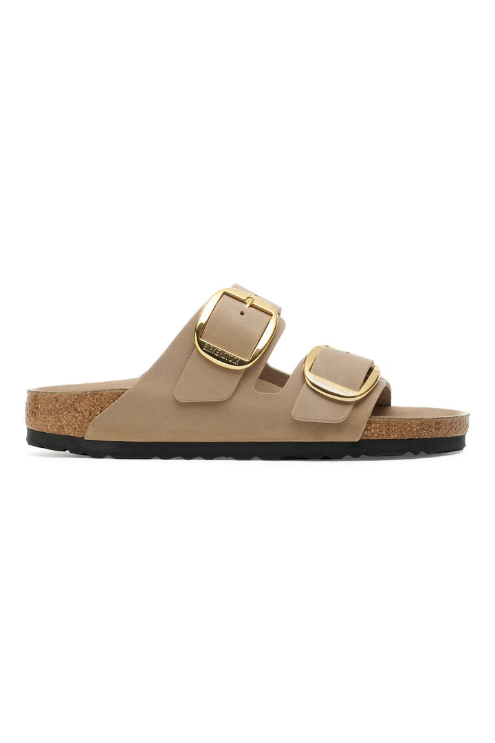 Beige sandal with gold buckles on a white background