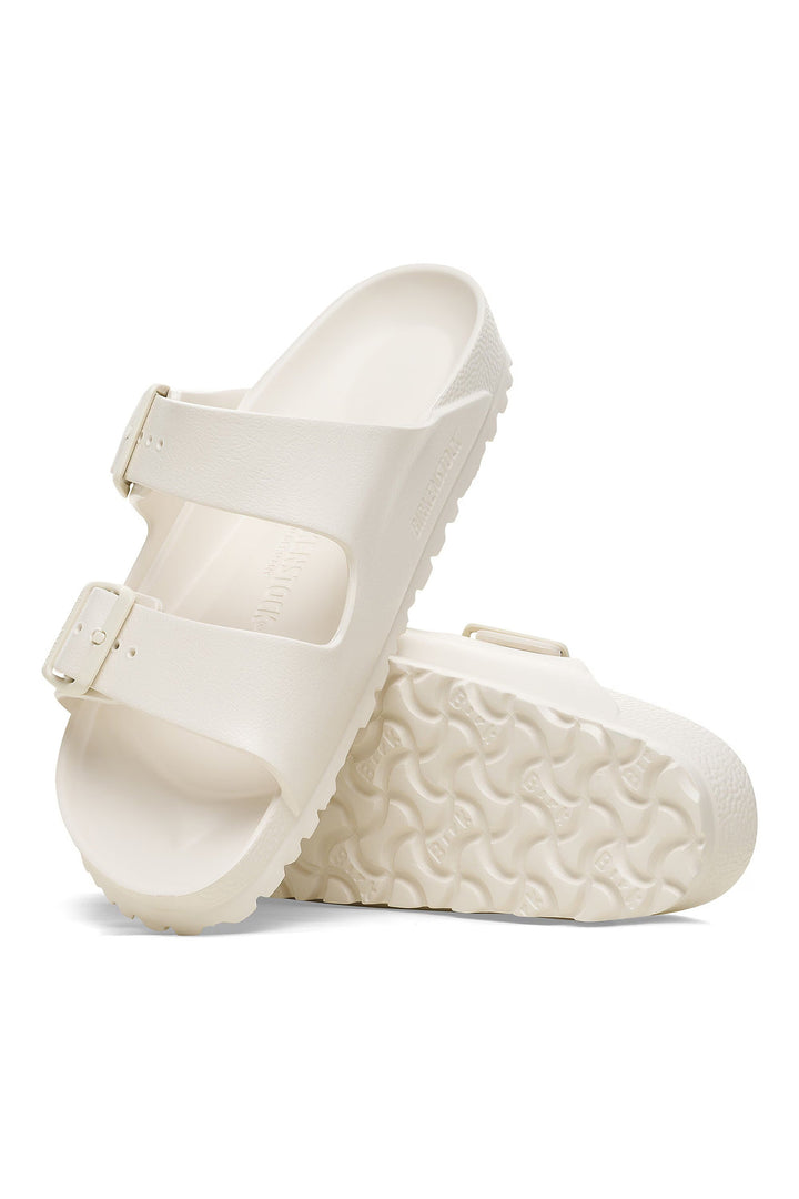 White sandals with textured sole on a white background