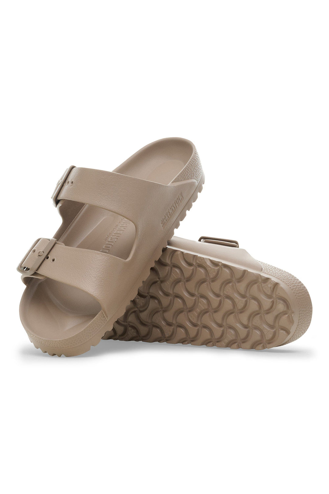 Pair of beige sandals on a white background