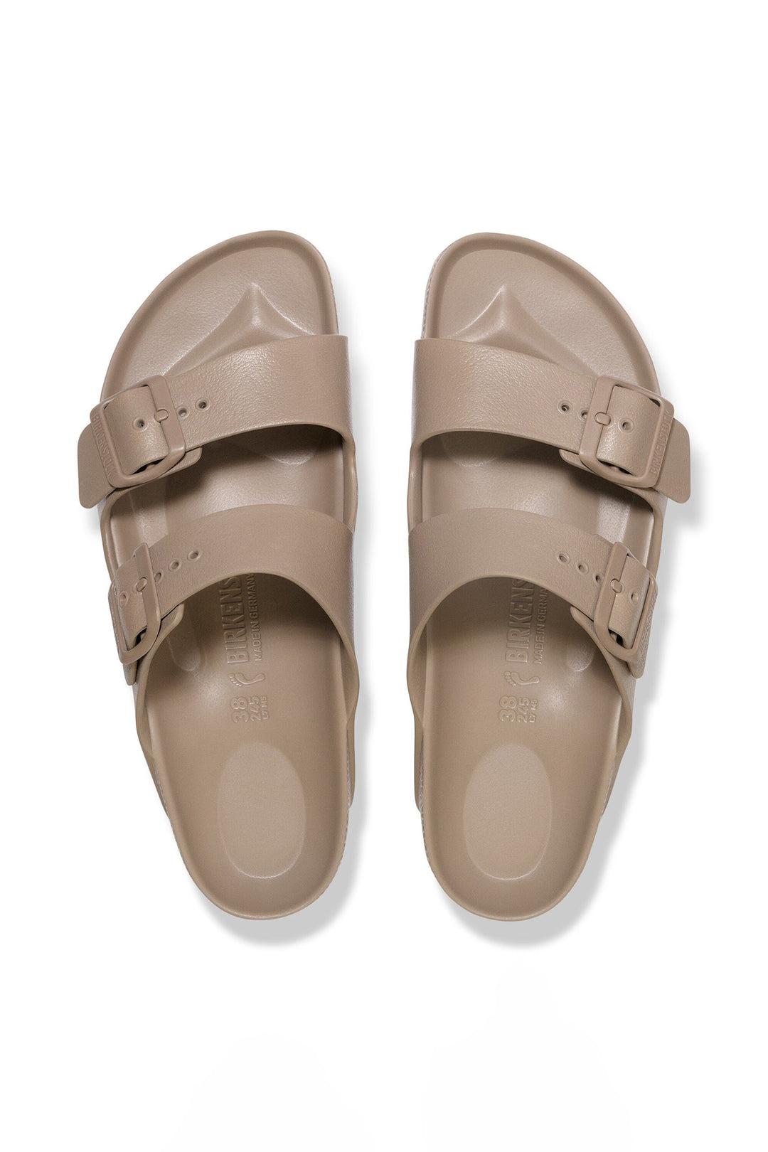 Pair of beige sandals with buckles on a white background