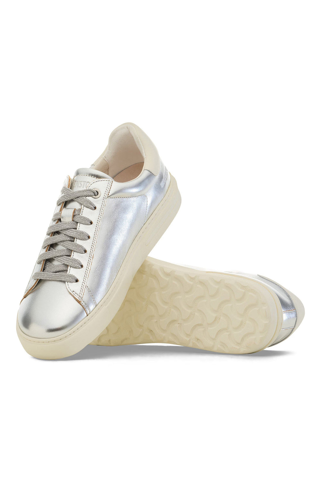 Silver and beige sneakers on a white background
