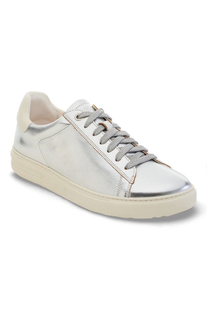 Silver sneaker with white sole on a white background