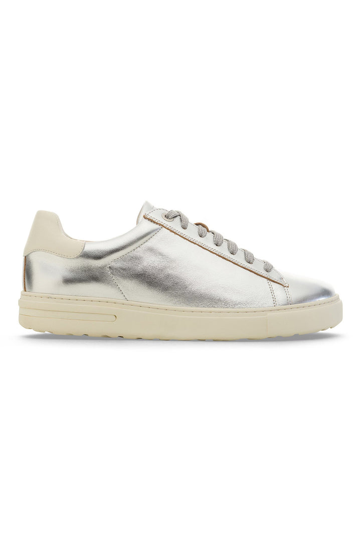 Silver sneaker with beige sole on a white background