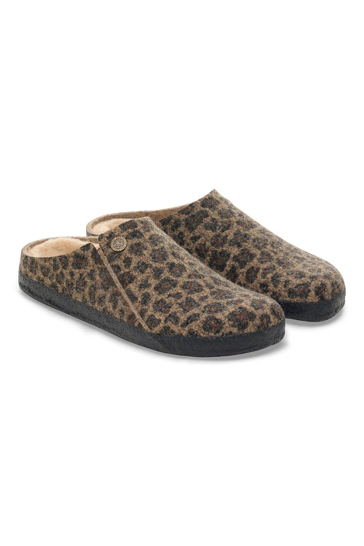 Pair of leopard print slippers on a white background