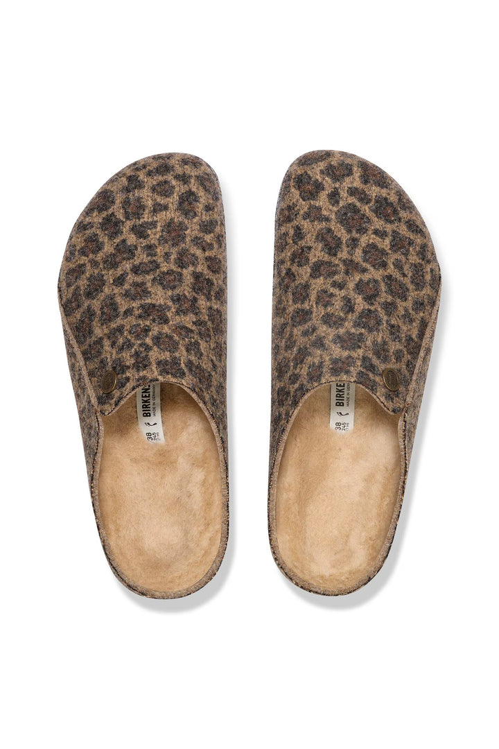 Pair of leopard print slippers on a white background