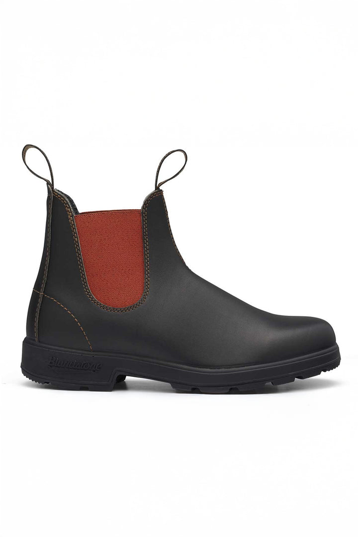 Black rubber boot with red inner lining on a white background
