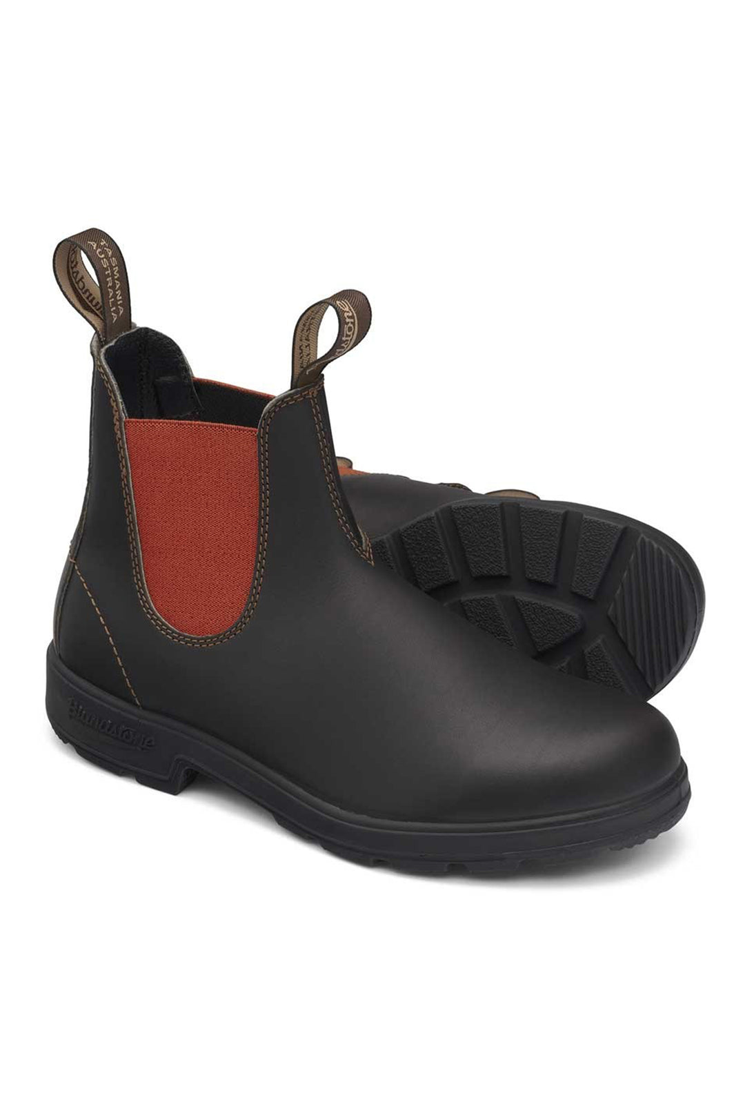 Black rubber boot with a red inner lining on a white background