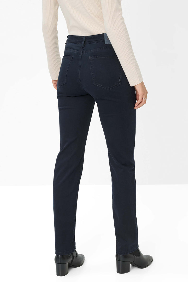 Person wearing dark blue jeans on a white background