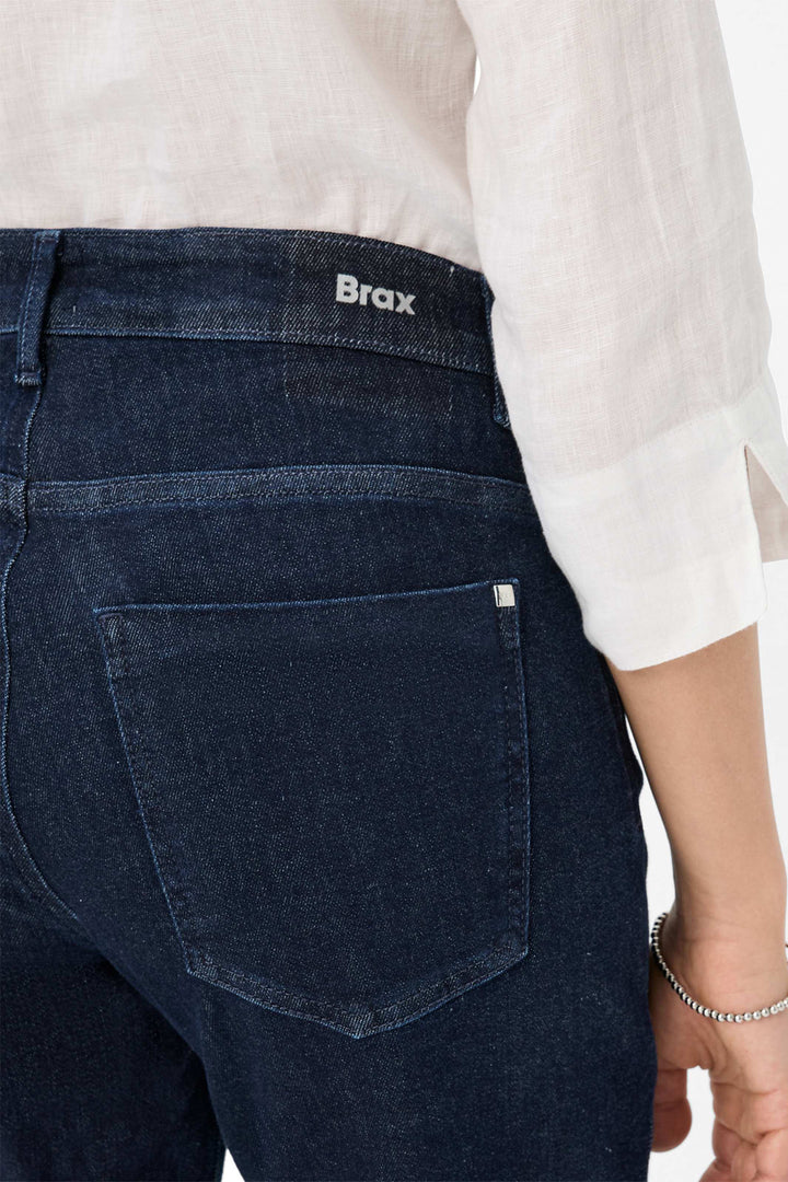 Dark blue jeans with 'Brax' branding on a white background
