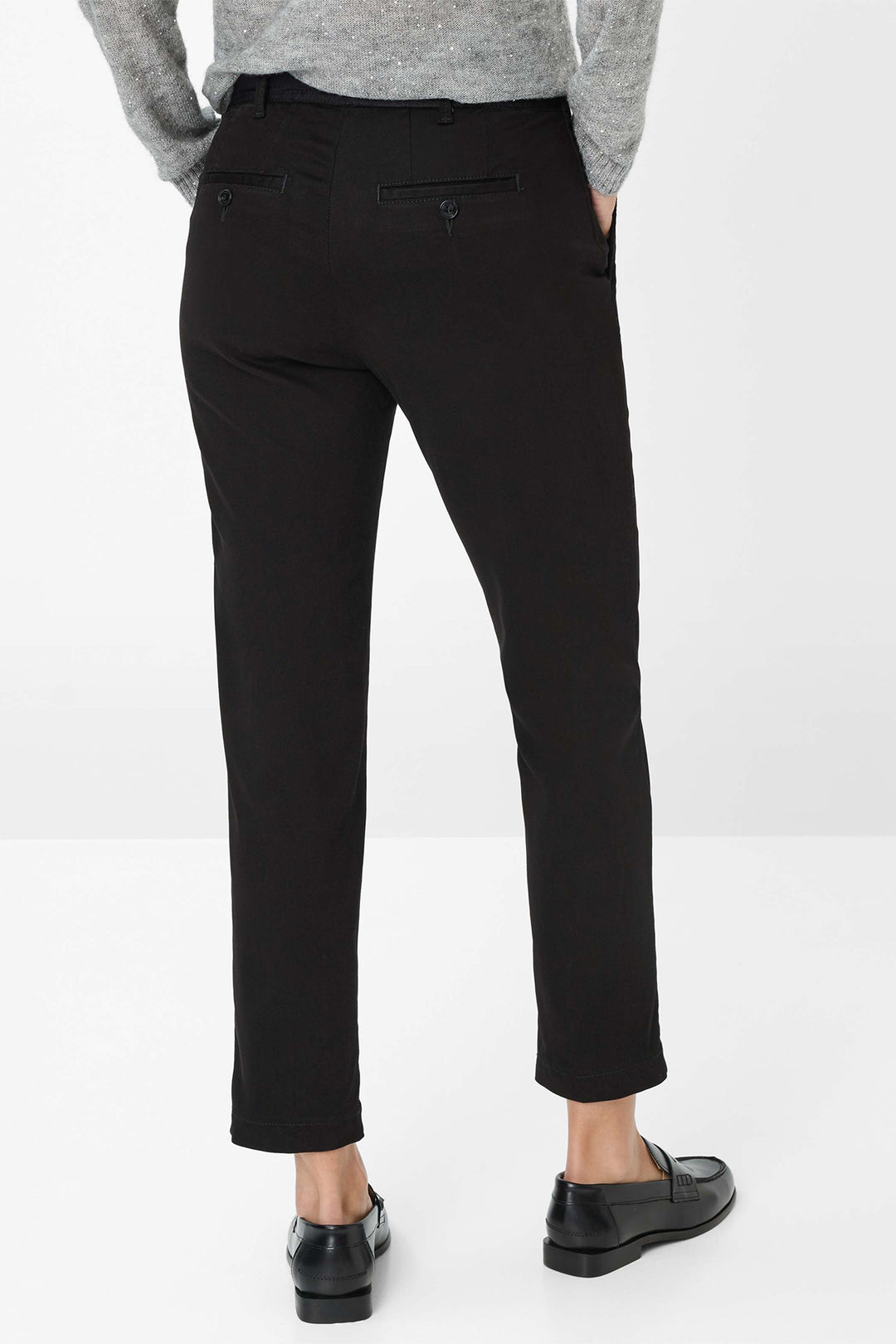 Person wearing black pants on a white background