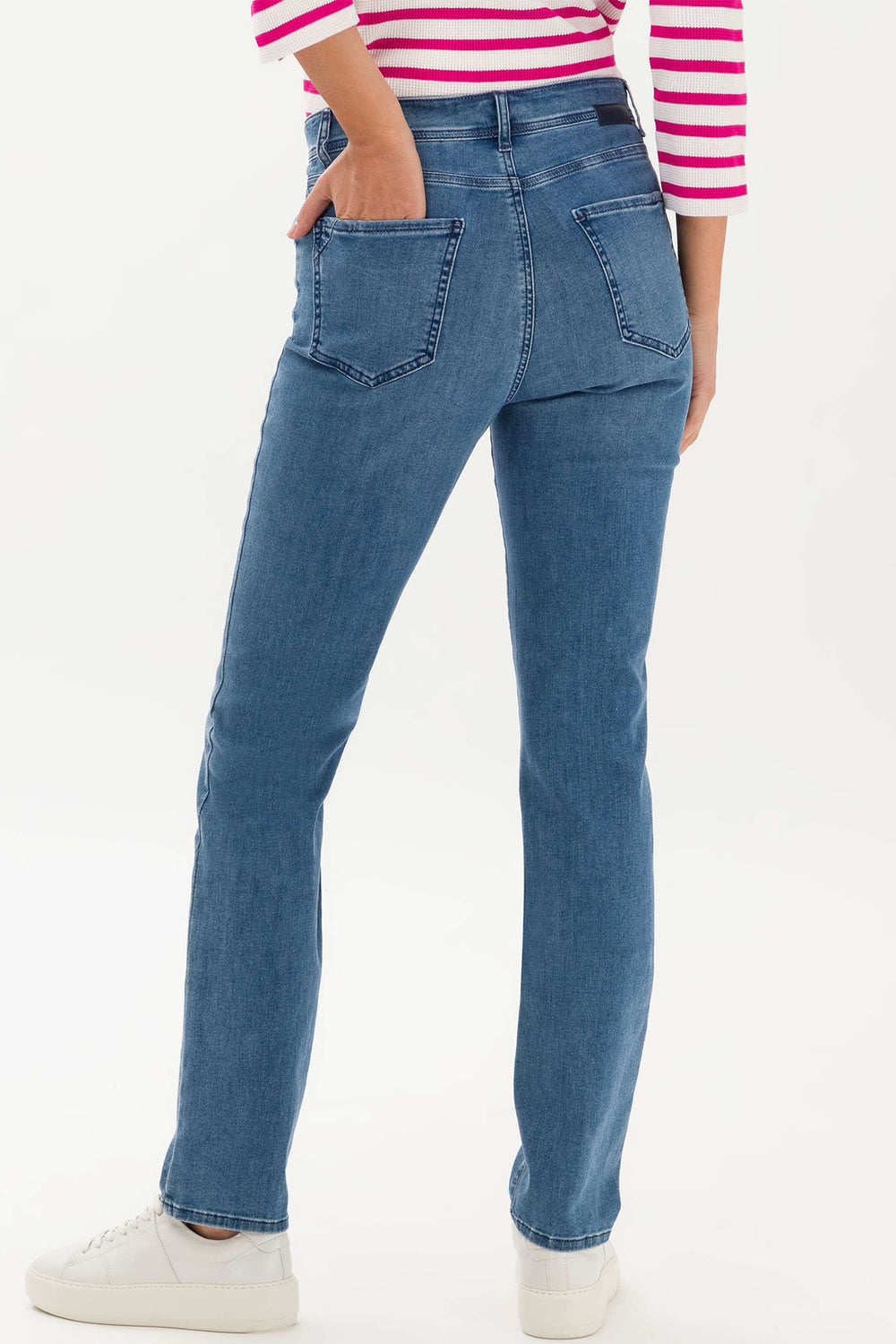 Person wearing blue jeans and a striped shirt on a white background