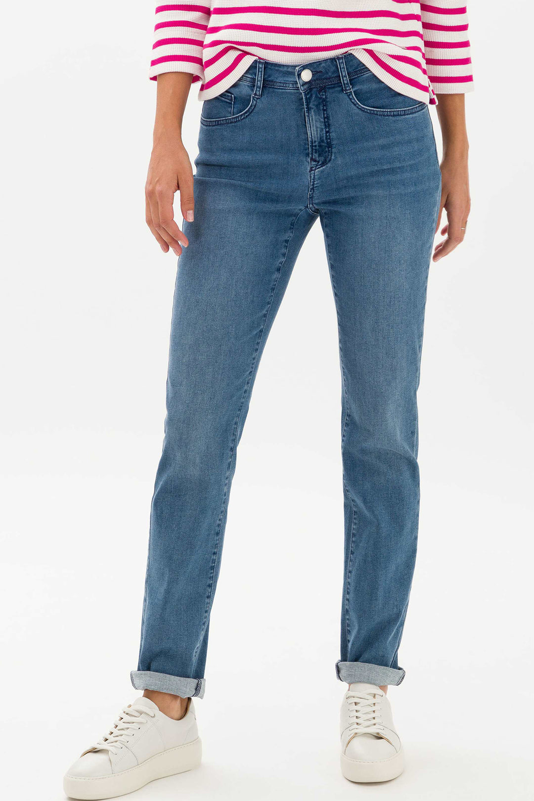 Person wearing blue jeans and a striped shirt on a white background