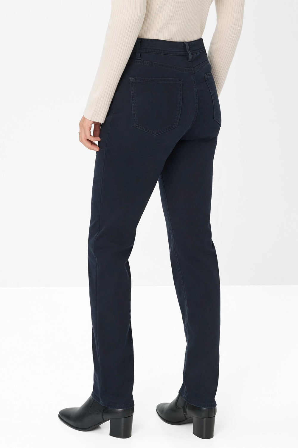 Navy blue pants worn by a person on a white background