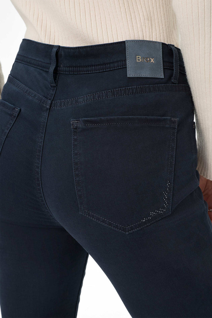 Navy blue jeans with a brand label on a white background