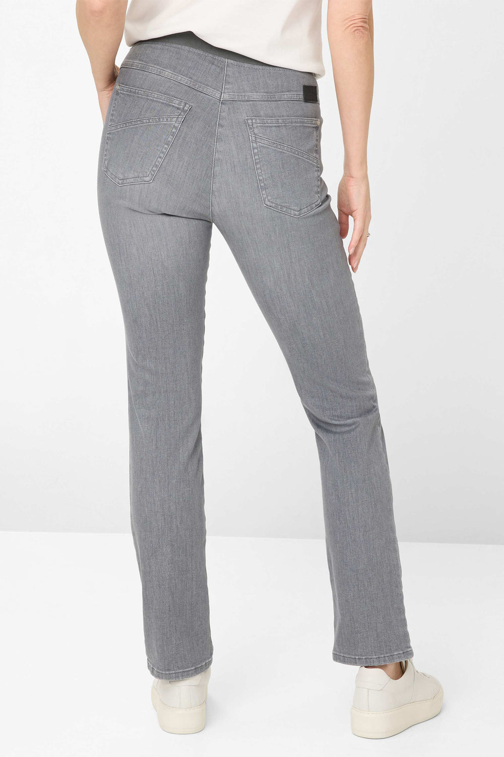 Person wearing gray jeans on a white background