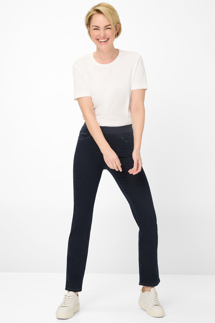 Woman wearing a white t-shirt and black pants on a white background