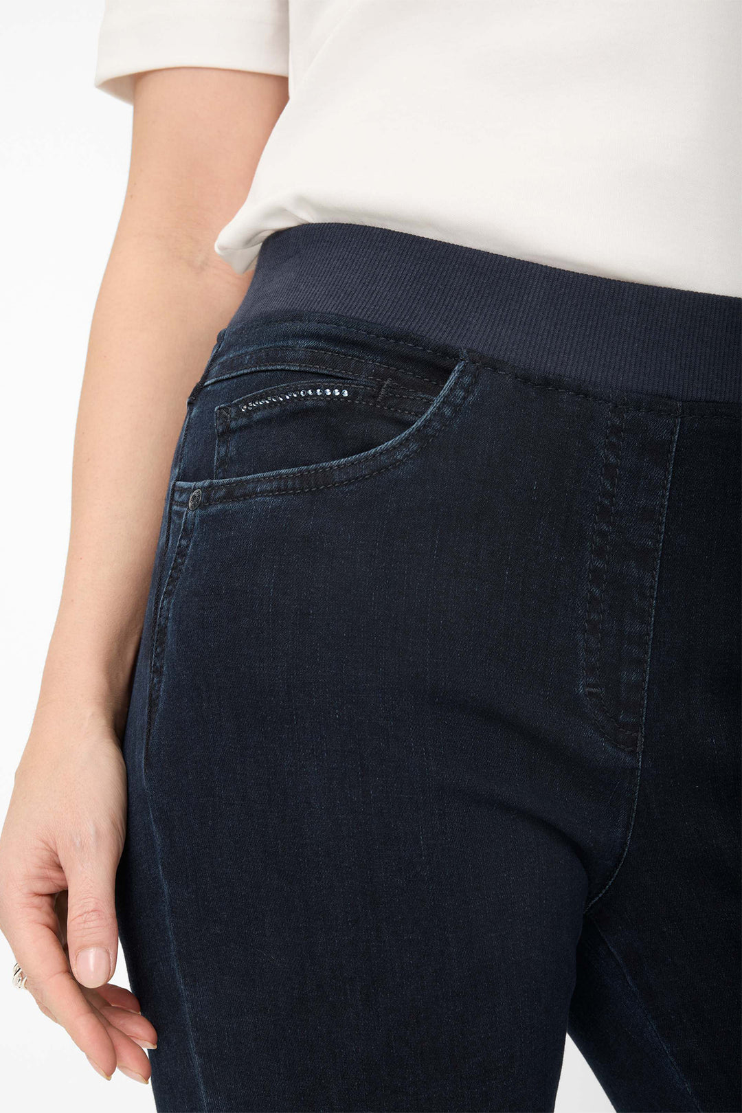 Dark blue jeans with a visible brand logo on a white background