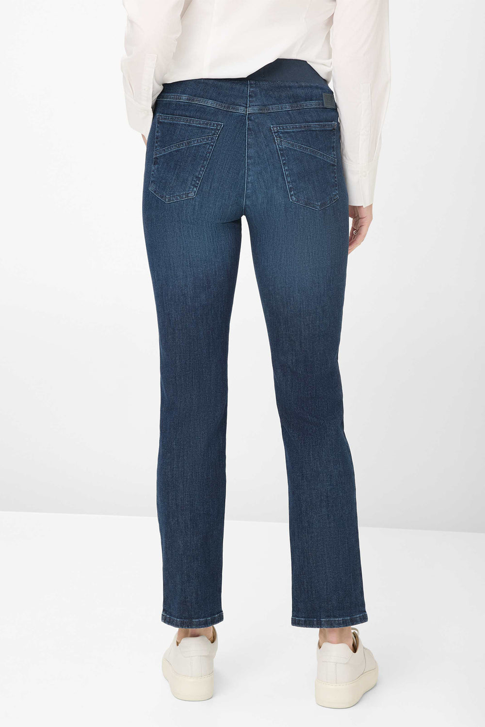 Person wearing blue jeans on a white background