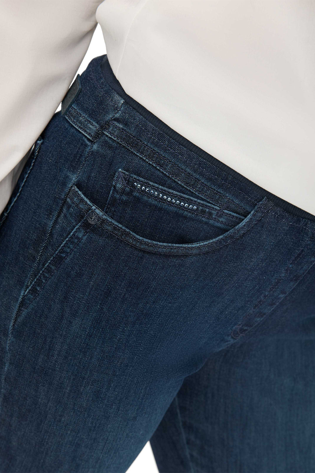 Close-up of dark blue jeans on a white background