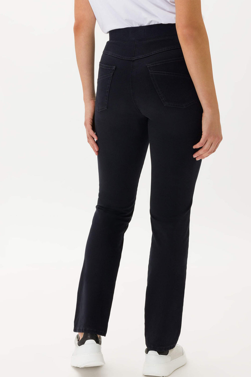 Person wearing black pants on a white background