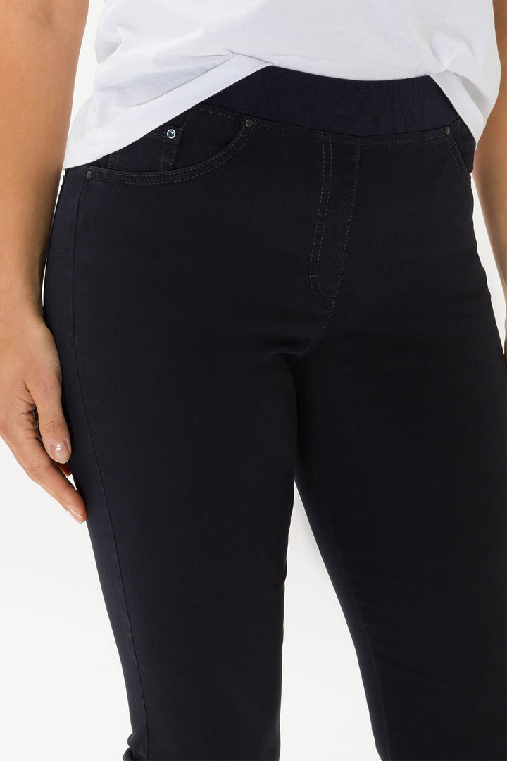 Black pants worn by a person on a white background