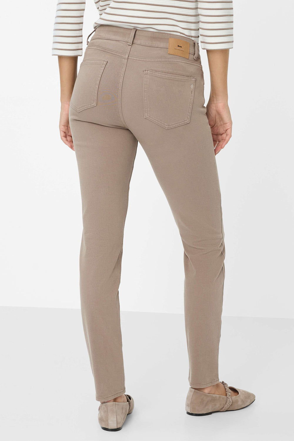 Beige pants worn by a person on a white background