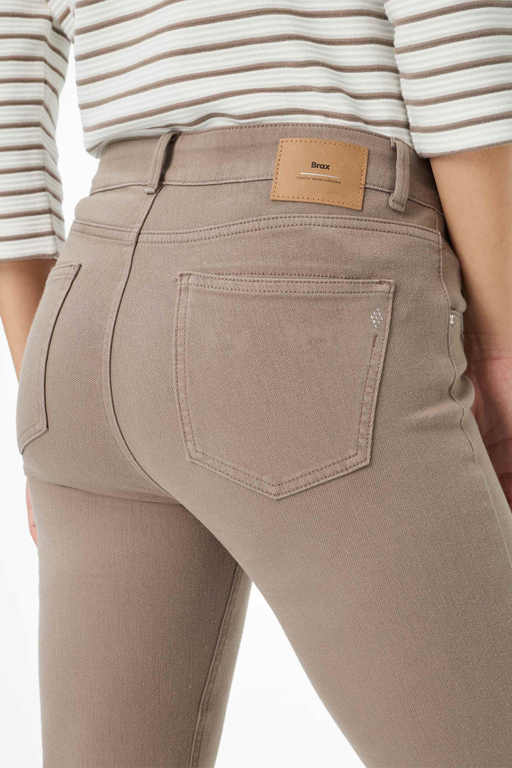 Brown pants with a brand label on a white background