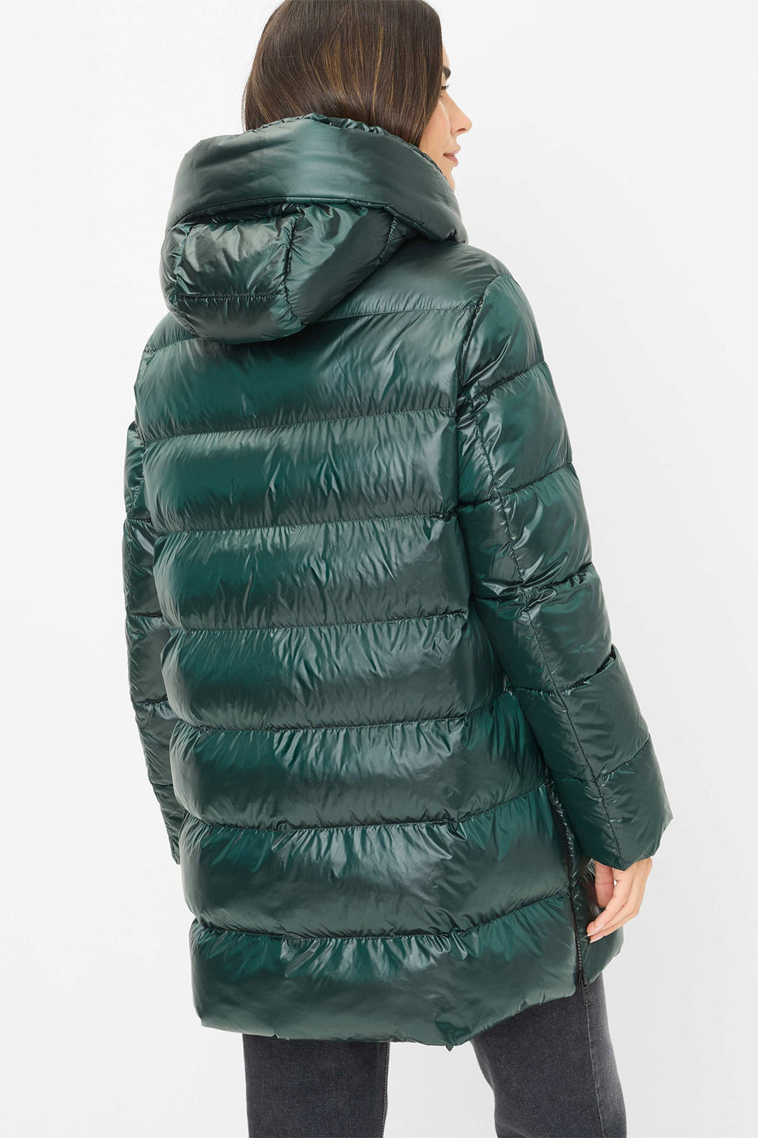 Green puffer jacket worn by a person on a white background
