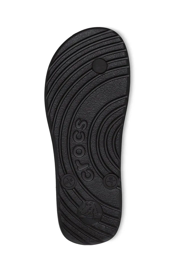 Black Crocs sandal sole on a white background