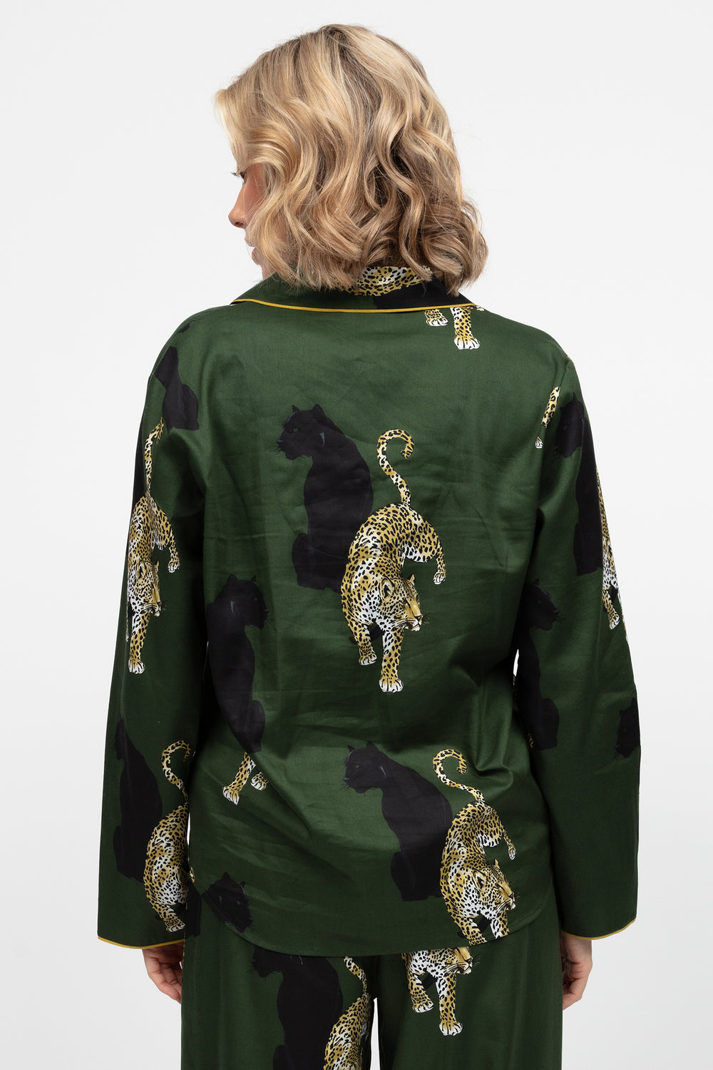 Green outfit with leopard patterns and gold accents on a white background