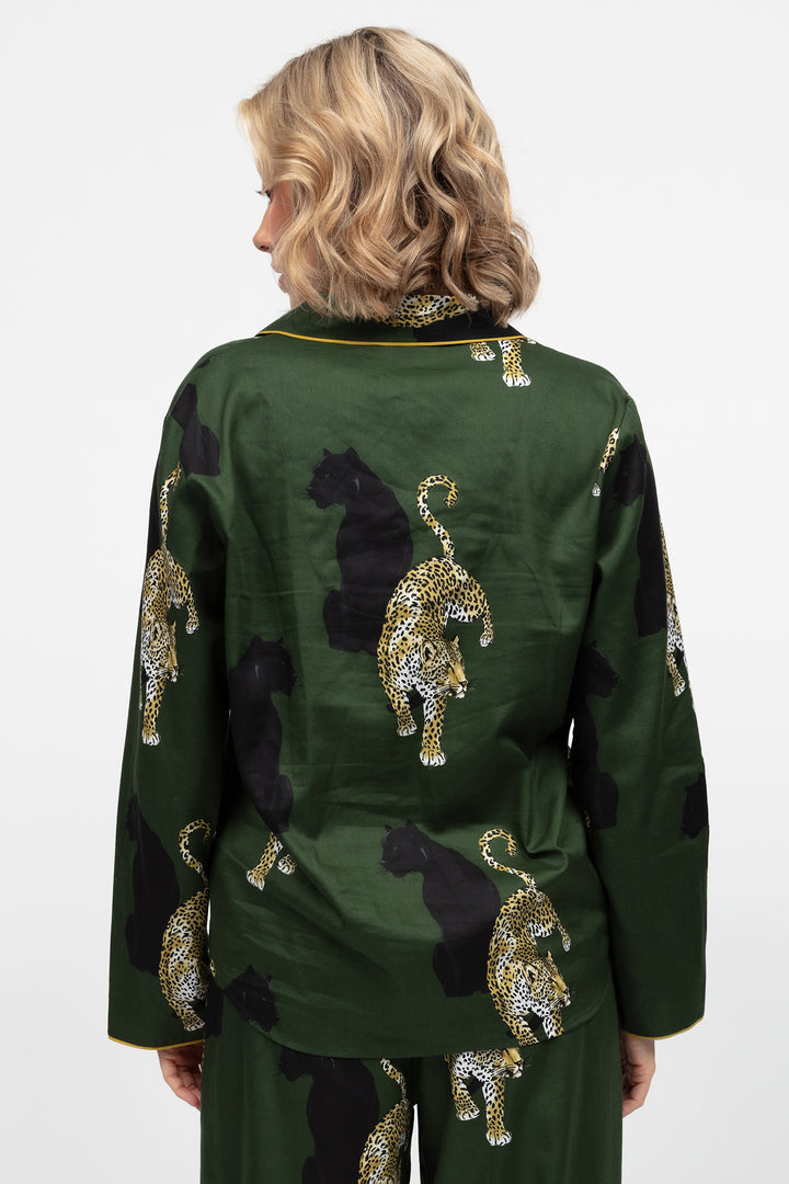 Green outfit with leopard patterns and gold accents on a white background