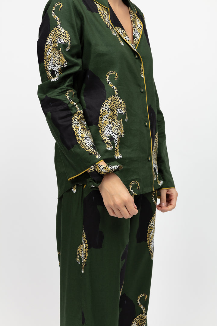 Green outfit with leopard embroidery on a white background