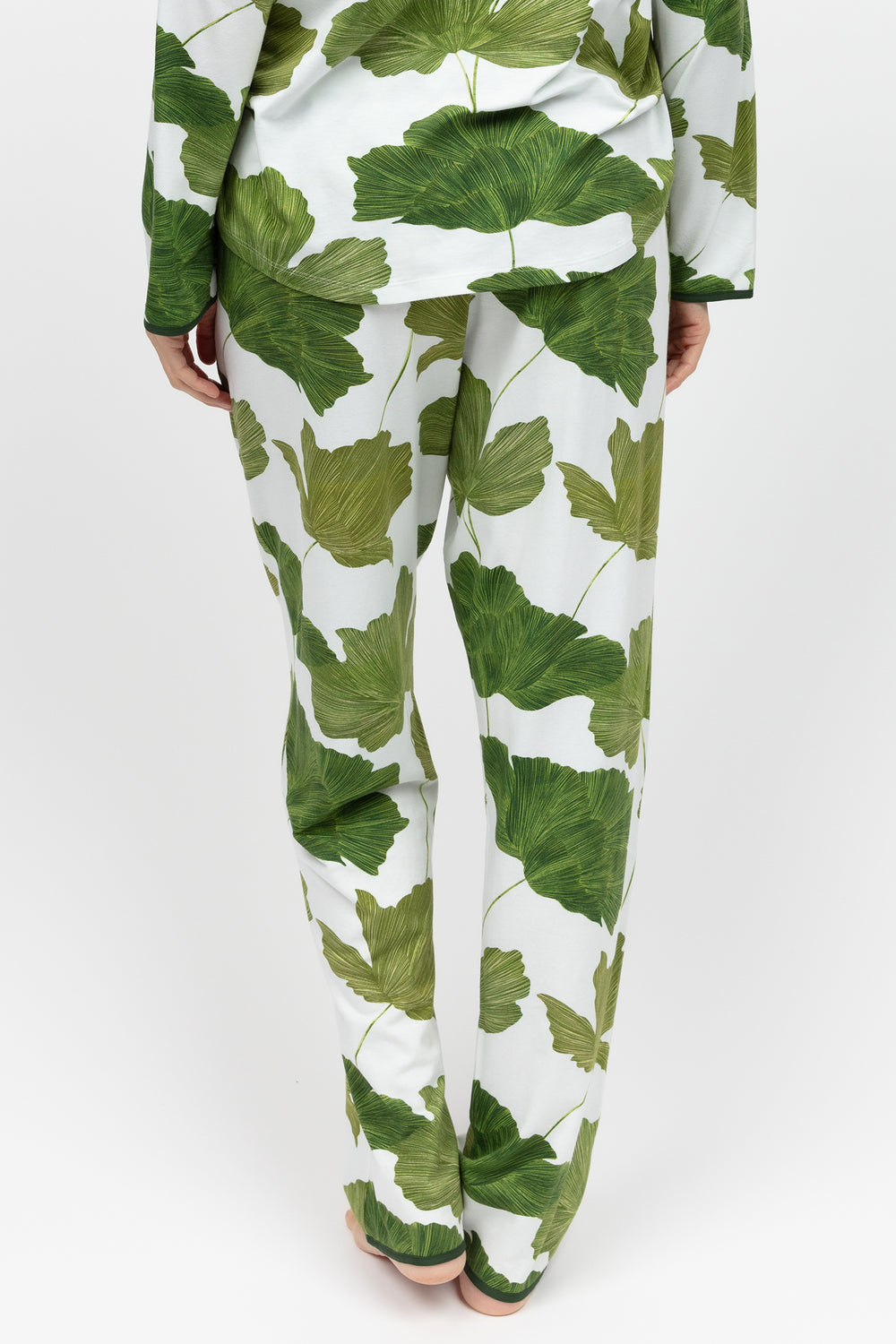 Green leaf-patterned pajama set on a white background