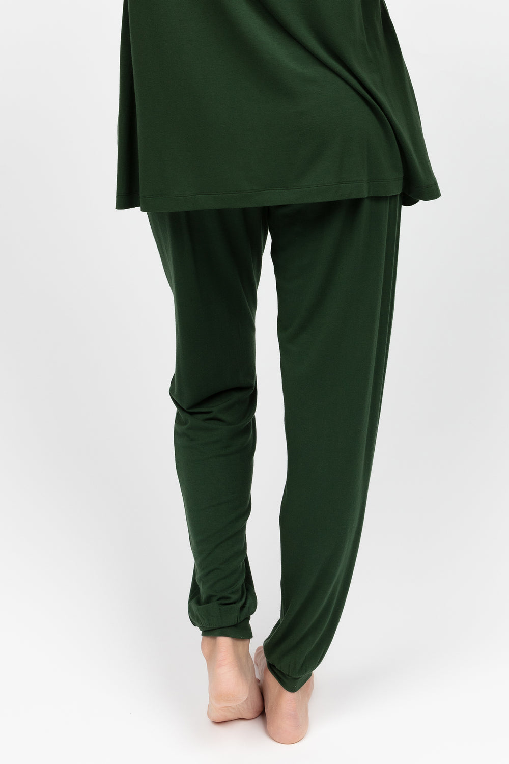 Green outfit with a top and pants on a white background