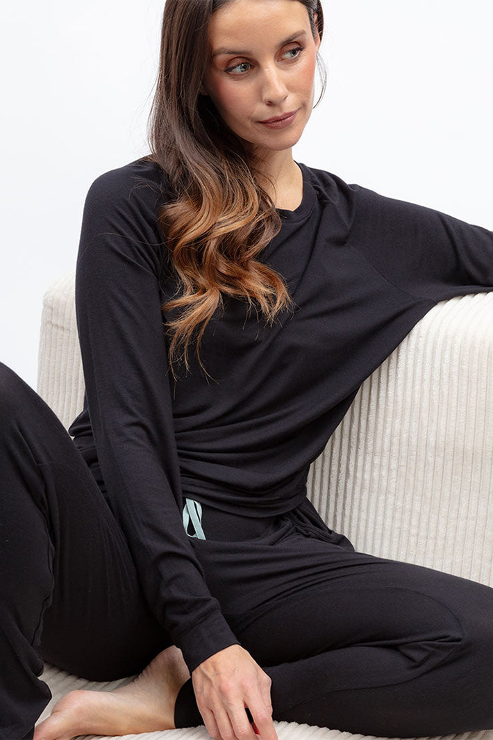 Cyberjammies 5581 Grace Black Jersey Pyjama Bottoms, worn sitting on a sofa