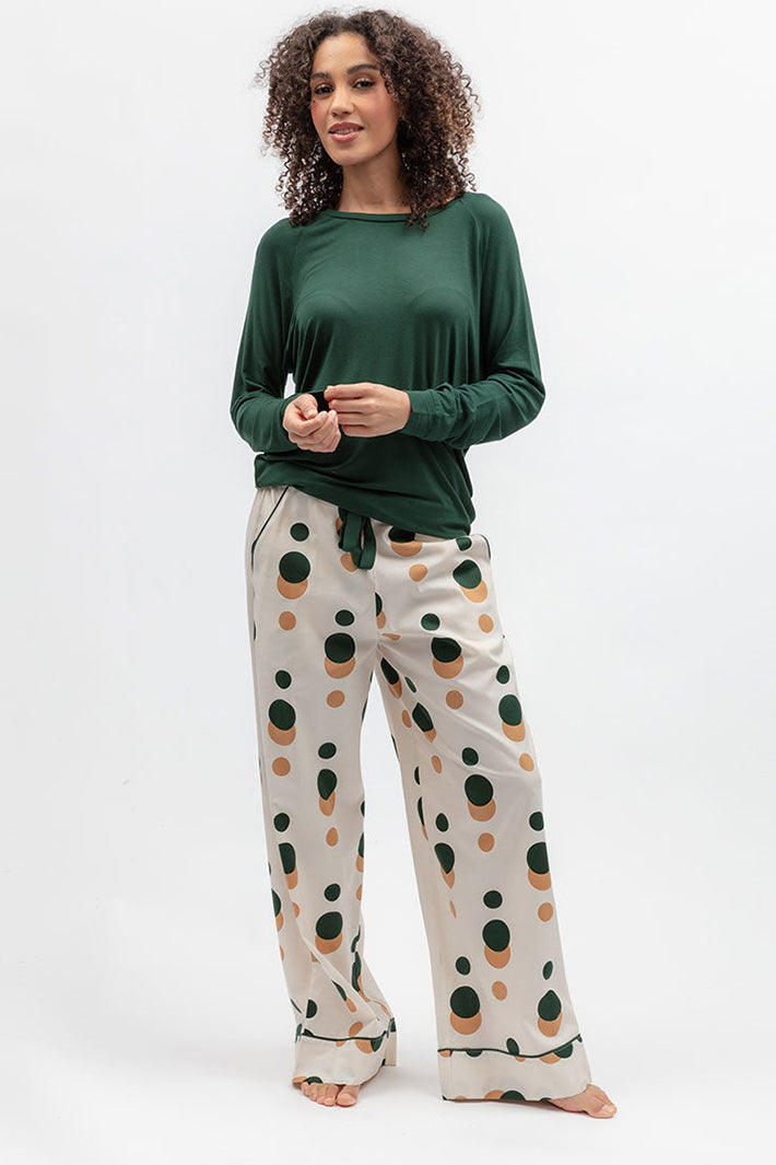 Cyberjammies 5656 Ember Dark Green Slouch Jersey Long Sleeve Pyjama Top, styled with printed wide-leg bottoms