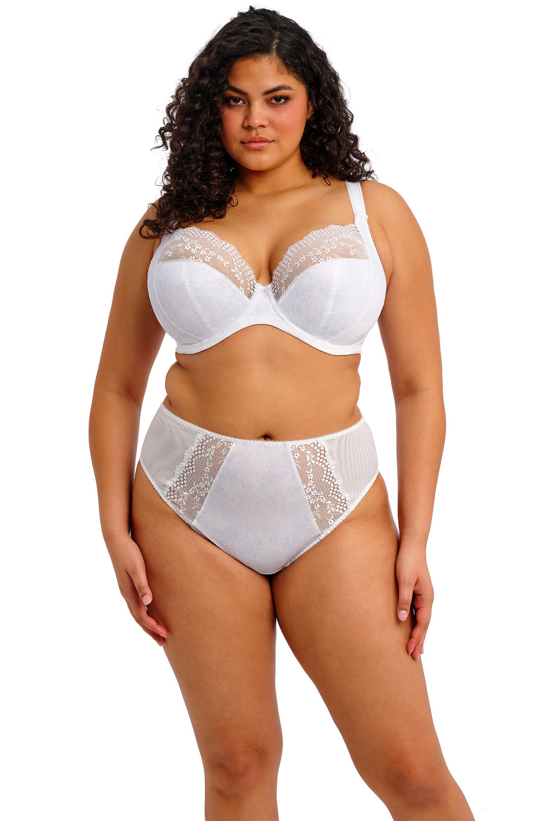 Woman wearing a white lace bra and panties set on a white background