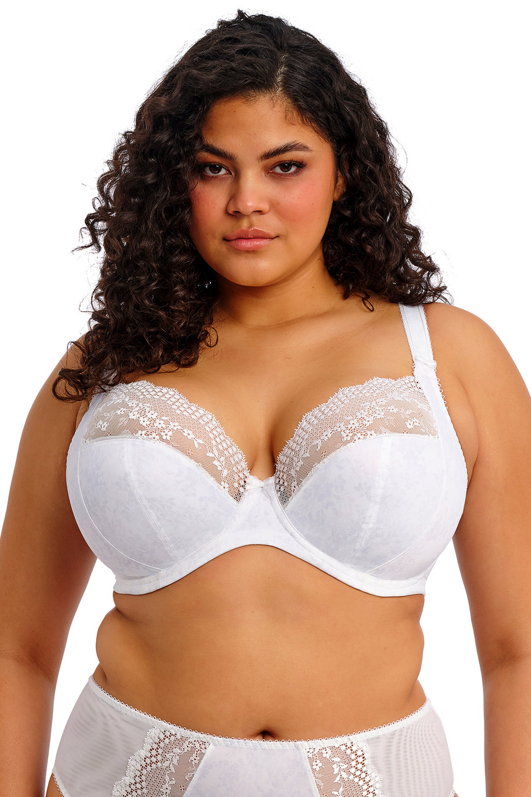 Woman wearing a white bra and panties set on a white background