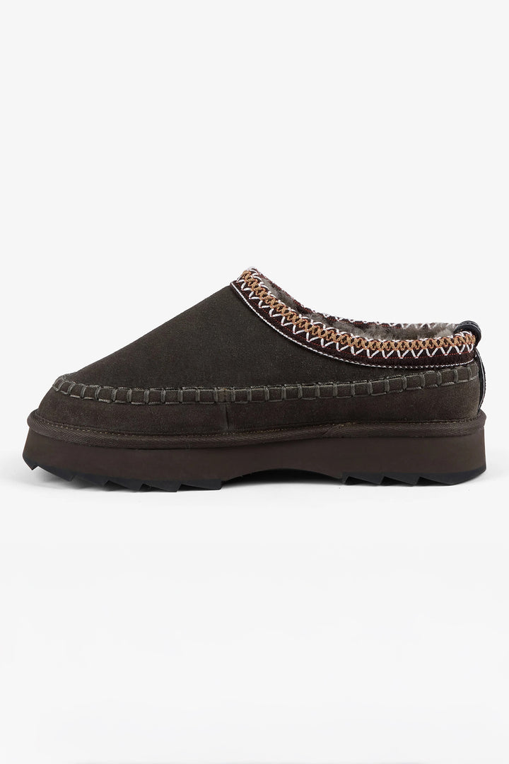 Brown slip-on shoe with textured trim on a white background