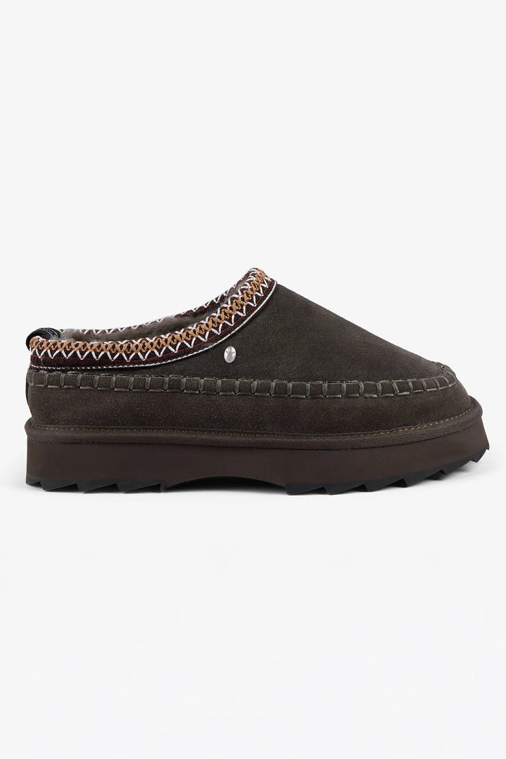Brown slipper with patterned trim on a white background